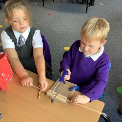 During our Design and Technology lessons, we have been learning to use a saw to make axles for out fire engines.